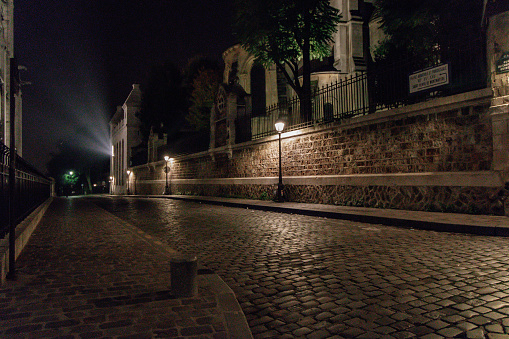 Empty street in a old residential district of Paris at nighttime