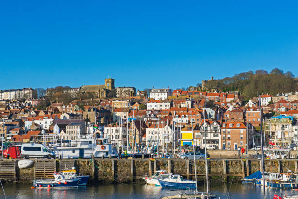 istock Harbor seafront town with medieval church on hill 1309435936