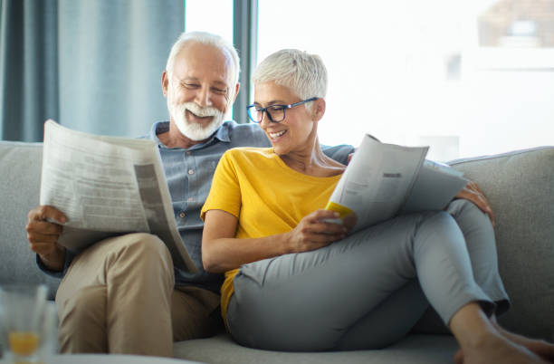 istock Mature couple reading magazines and having a conversation. 1309436295