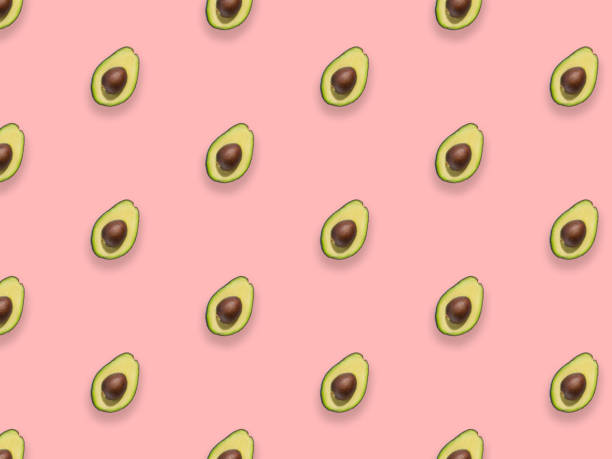 istock Seamless pattern of fresh ripe green avocado fruit isolated on pink background. Top view. Flat lay composition. 1309437254