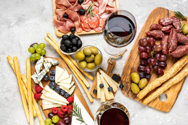 Traditional Italian appetizers antipasti Traditional Italian appetizers antipasti : salami, prosciutto, olives, parmesan cheese, pecorino, gorgonzola, grissini. Aperitif in Italy in Florence, Rome, aperitif in Milan. Charcuterie board red wine. prosciutto brie stock pictures, royalty-free photos & images