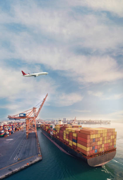 istock Airplane flying over the container port. 1309438316