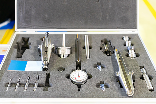 Sample cross section tool holder with dial gauge end mill and other various equipment for cnc machining center process in box