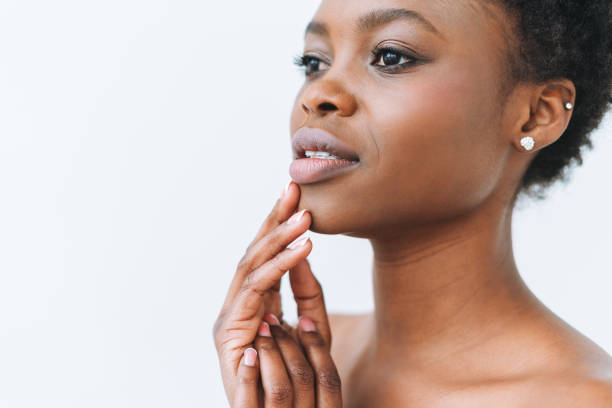 Beauty portrait of beautiful young African American woman hands near face isolated on the white background Beauty portrait of beautiful young African American woman hands near face isolated on white background black skin stock pictures, royalty-free photos & images