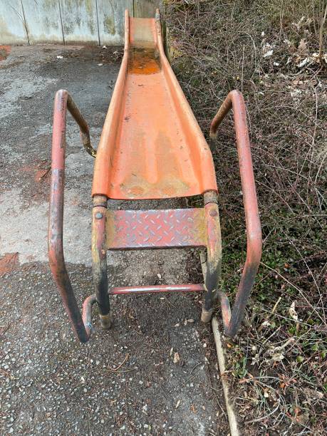 istock Decommissioned, rusted children's slide on a parking lot 1309443095