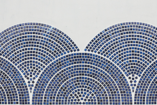 Blue tiled drawing on a white wall.