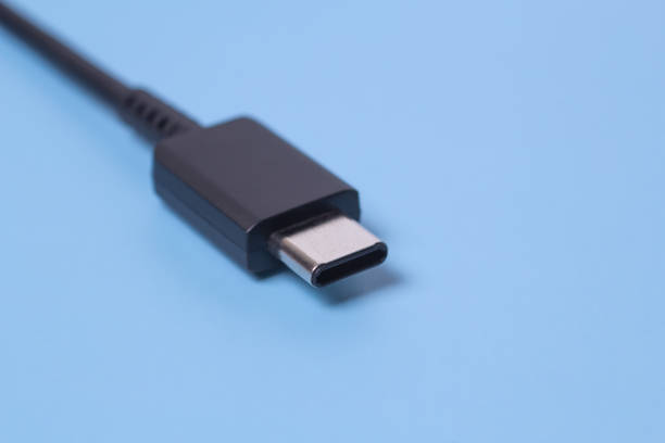 Close up photo of usb type c connector on blue blurred background.