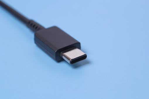 Close up photo of usb type c connector on blue blurred background. selected focus