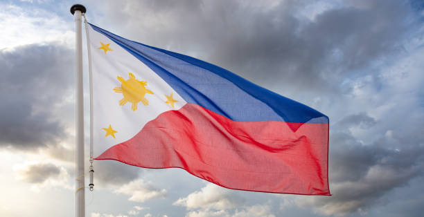 istock Philippines flag waving against cloudy sky 1309447255