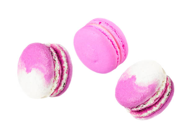 istock French pastry macarons three lilac pieces isolated on white background. 1309447686