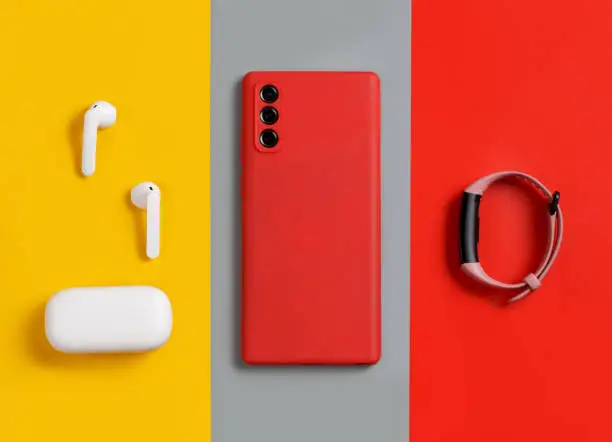 Photo of Smartphone, white wireless earphones and smart watch