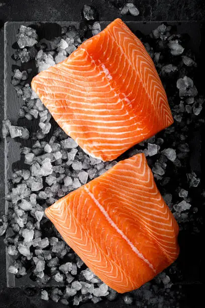 Salmon fillet. Slices of fresh raw salmon fish on ice