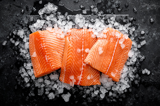 Salmon fillet. Slices of fresh raw salmon fish on ice