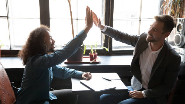 istock Multiethnic millennial men best friends uniting hands in high five 1309449039