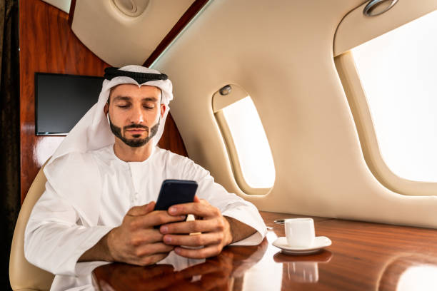 istock Arabian man wearing kandora flying on private jet 1309449144