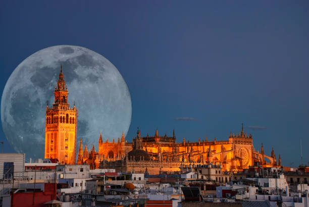 istock A full moon behind the illuminated cathedral in Seville, Spain 1309449706