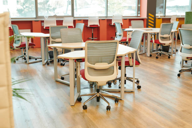 istock Interior of contemporary large open space office with many chairs by tables 1309449784