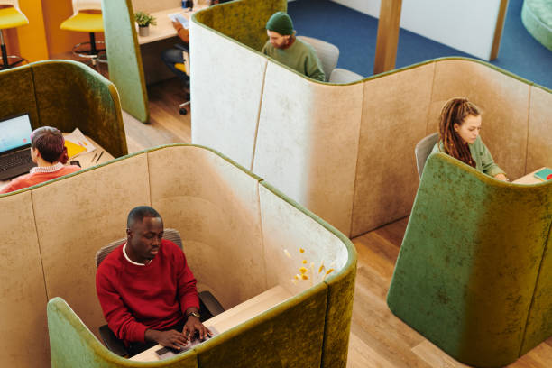 istock Several young intercultural co-workers in casualwear working individually 1309449830