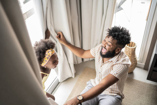 istock Father and daughter playing hide and seek at home 1309450206