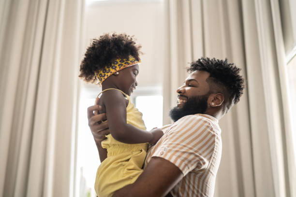 istock Father embracing daughter at home 1309450253