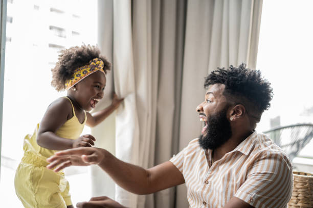 istock Father and daughter playing at home 1309450263