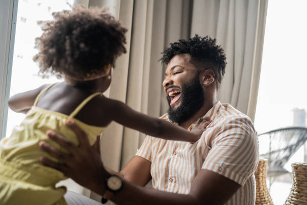 istock Father and daughter playing at home 1309450269
