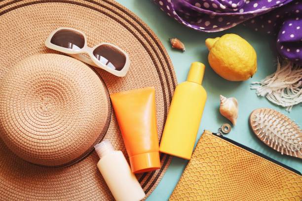 istock Summer beach essentials flat lay photography. Sunscreen for sensitive skin, moisturizer for face, travel size shampoo, wooden hair brush, straw hat, sunglasses and cosmetic bag 1309451170