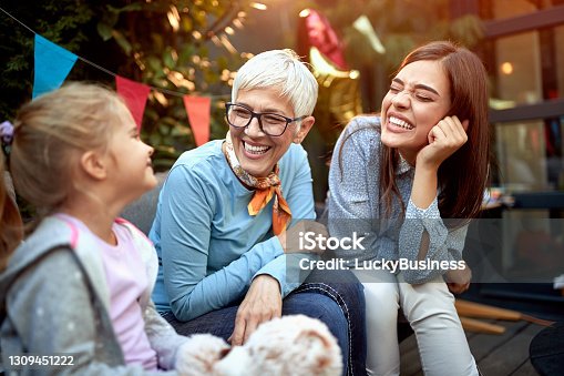 istock sweet little girl with her mother and grandmother. Three generation concept 1309451222