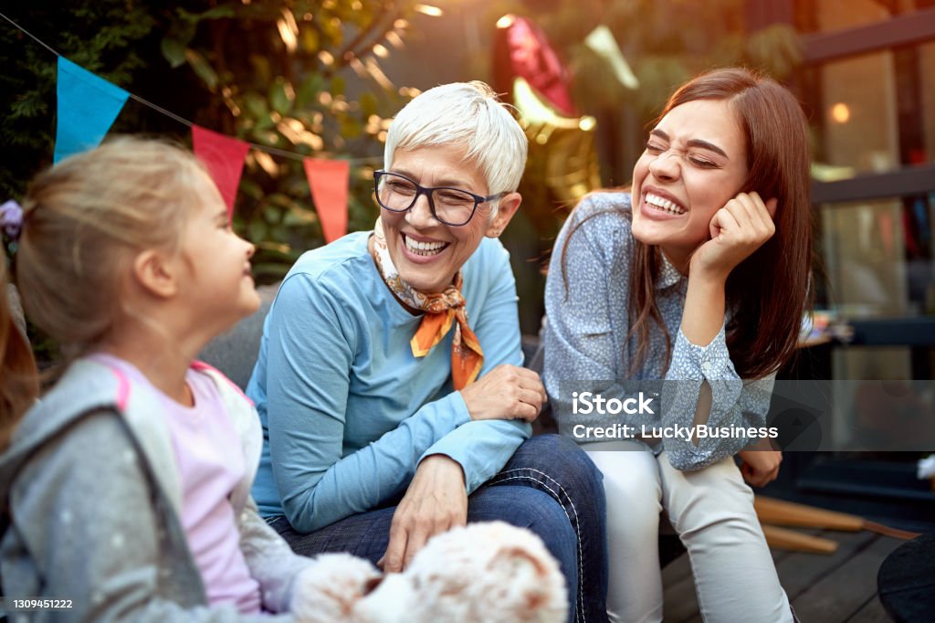 sweet little girl with her mother and grandmother. Three generation concept sweet little girl with her mother and grandmother at birthday party. Three generation concept Family Stock Photo