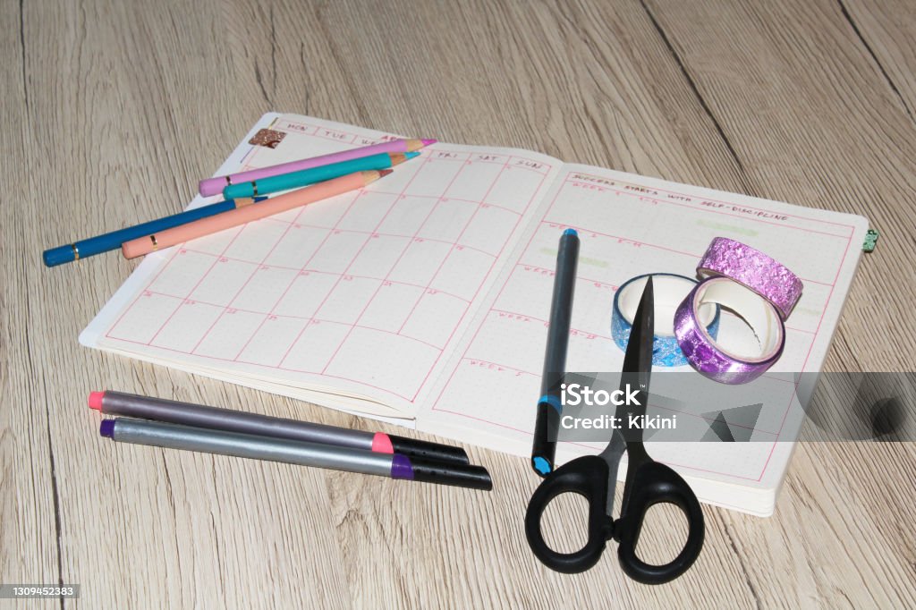 Bullet Journal Open bullet journal. Monthly review. Bullet journal with supplies for decorating and writing. Bullet Journal Stock Photo