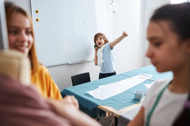 istock Cheerful female kids working in sewing workshop 1309458096