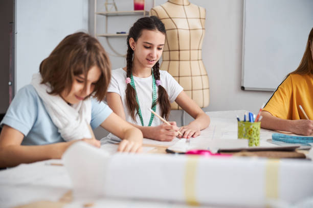 istock Cute female kids working in sewing workshop 1309458112