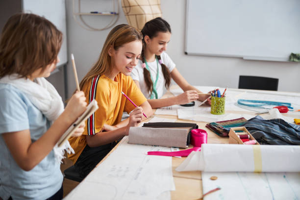 istock Joyful female children working in sewing workshop 1309458125