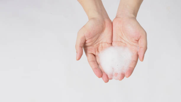 istock Hand washing gesture with foaming hand soap on white background. 1309458195