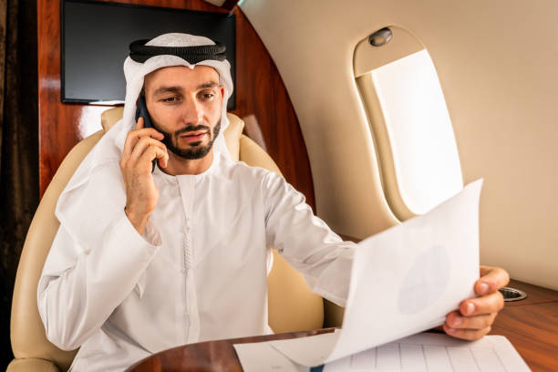 istock Arabian man wearing kandora flying on private jet 1309459358