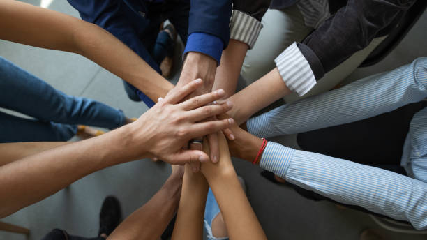 istock Diverse people business partners friends colleagues stacking palms in pile 1309460461