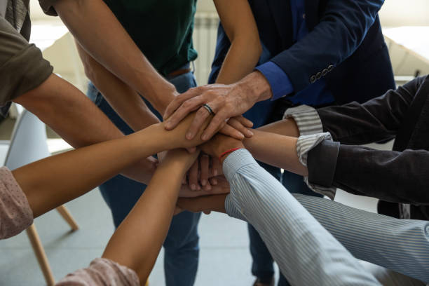 istock Motivated diverse business people putting hands together demonstrating unity 1309460465