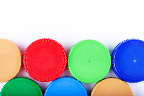 istock A lot of plastic bottle caps on a white background. Recycling collection and processing plastic bottle caps. Cap material is recyclable. 1309461805