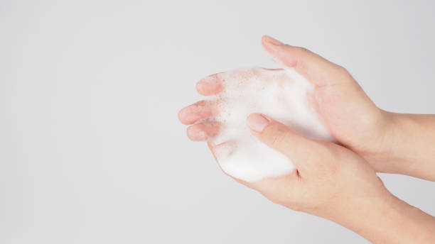 istock Hands washing gesture with foaming hand soap on white background. 1309462893