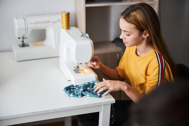 istock Cute girl seamstress sewing fabric in workshop 1309464693