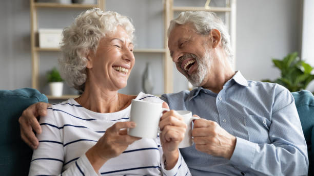 istock Overjoyed middle aged couple communicating drinking coffee. 1309468373