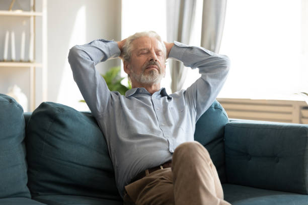 istock Relaxed smiling middle aged man sleeping on comfortable couch. 1309468386
