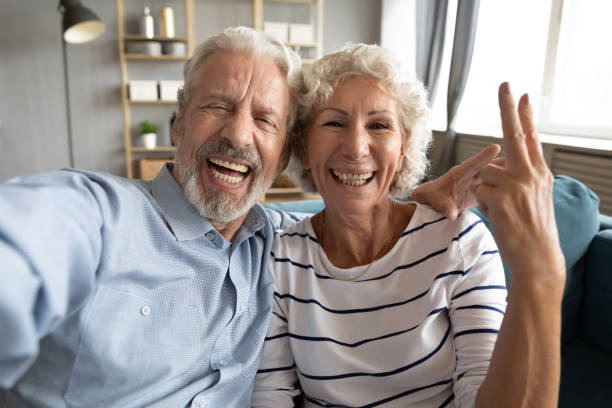 istock Overjoyed sincere laughing middle aged couple holding video call. 1309468388