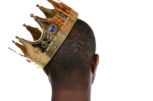 Crown leaning on the head of a African American male's head.