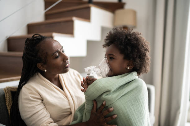 istock Mother helping daughter using nebulizer during inhalation therapy 1309469122