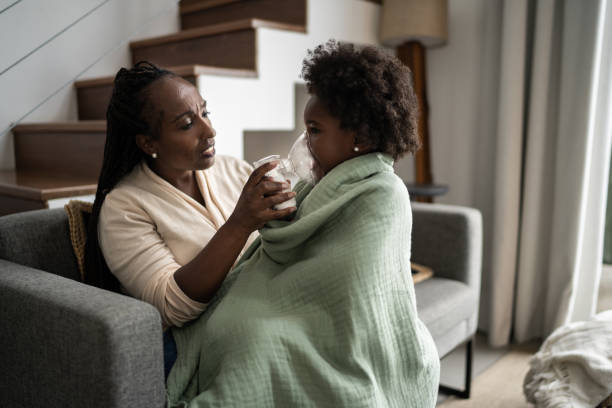 istock Mother helping daughter using nebulizer during inhalation therapy 1309469125