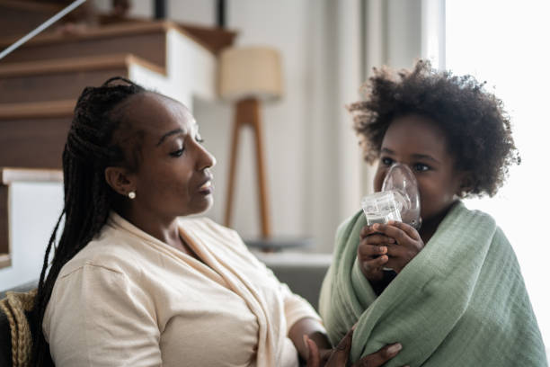 istock Mother helping daughter using nebulizer during inhalation therapy 1309469138
