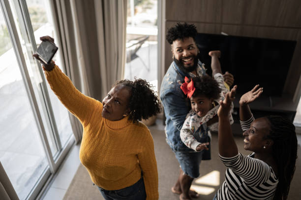 istock Family using mobile phone doing a video call or a selfie at home 1309471773