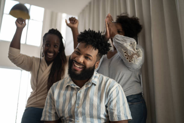 istock Family doing a video call or watching something and dancing at home 1309471793