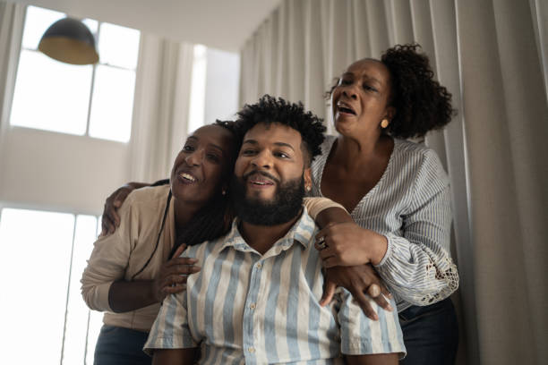 istock Family doing a video call or watching something together at home 1309471800